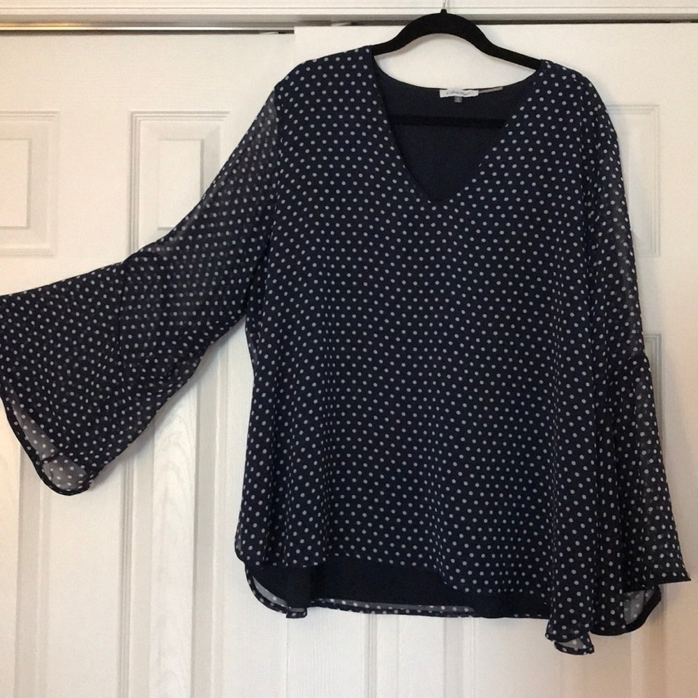 Navy blue fully lined top with white polka dots
